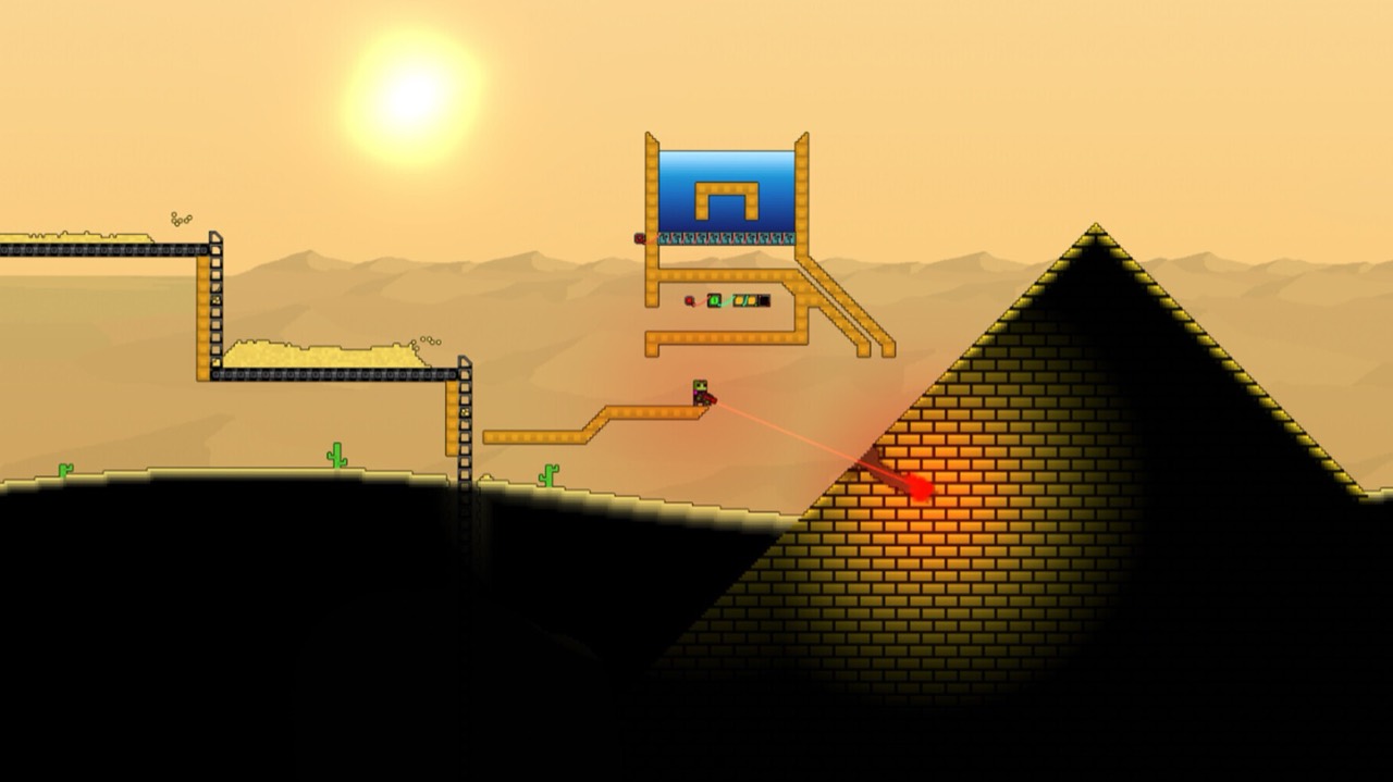 A desert surface in Sandustry at low sun: conveyor platforms and a raised water tank on the left, and the player cutting into a large brick pyramid with a red laser.